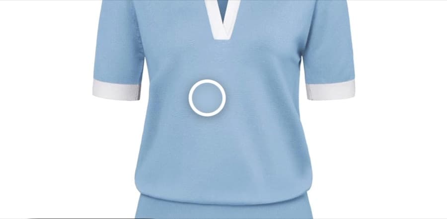 A light blue knit top with the color sampler placed on the fabric